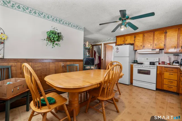a kitchen with stainless steel appliances granite countertop a sink a stove and a refrigerator