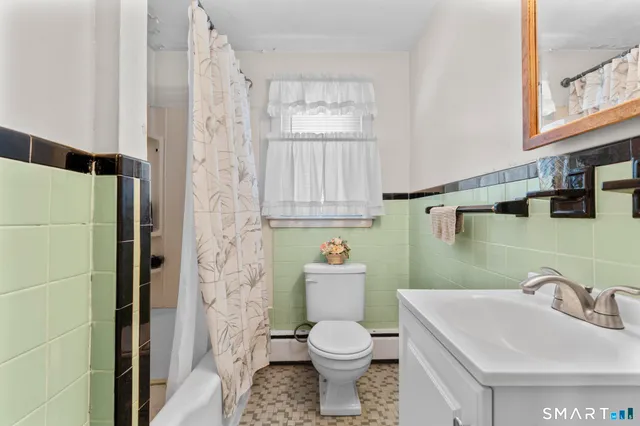 a bathroom with a sink a toilet and a window