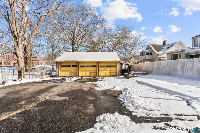 a view of a large house with a yard covered in snow