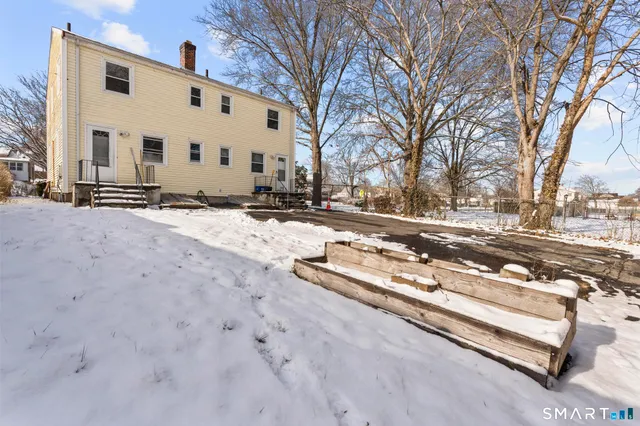 a view of a yard with snow on the road