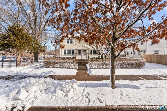 a view of a yard with snow on the road