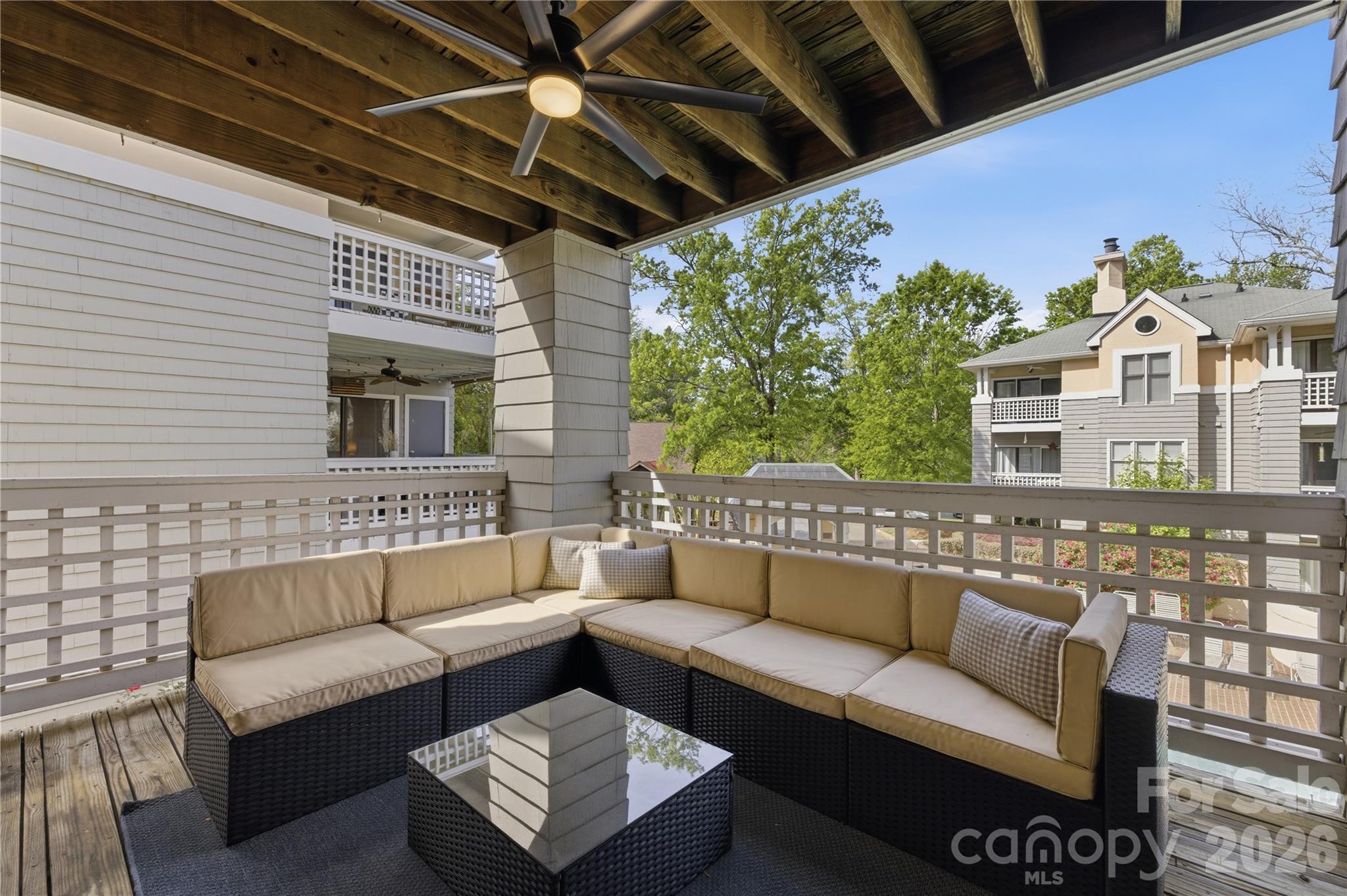 308 Queens Road, Unit 32 Charlotte, NC 28204 - Photo 21 of 30 a view of a patio with couches and a potted plant on a table