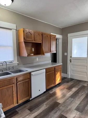 a kitchen with a sink stove and cabinets