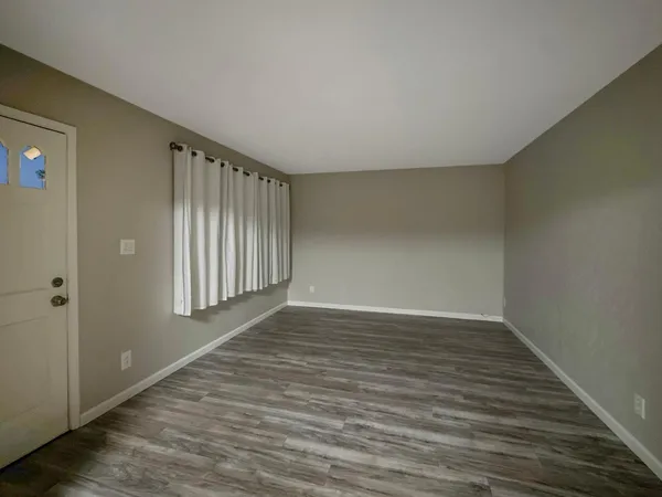 a view of an empty room and wooden floor