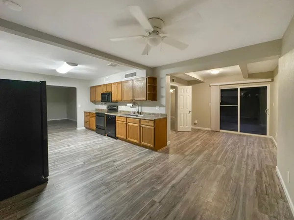 a large kitchen with stainless steel appliances granite countertop a stove and a refrigerator