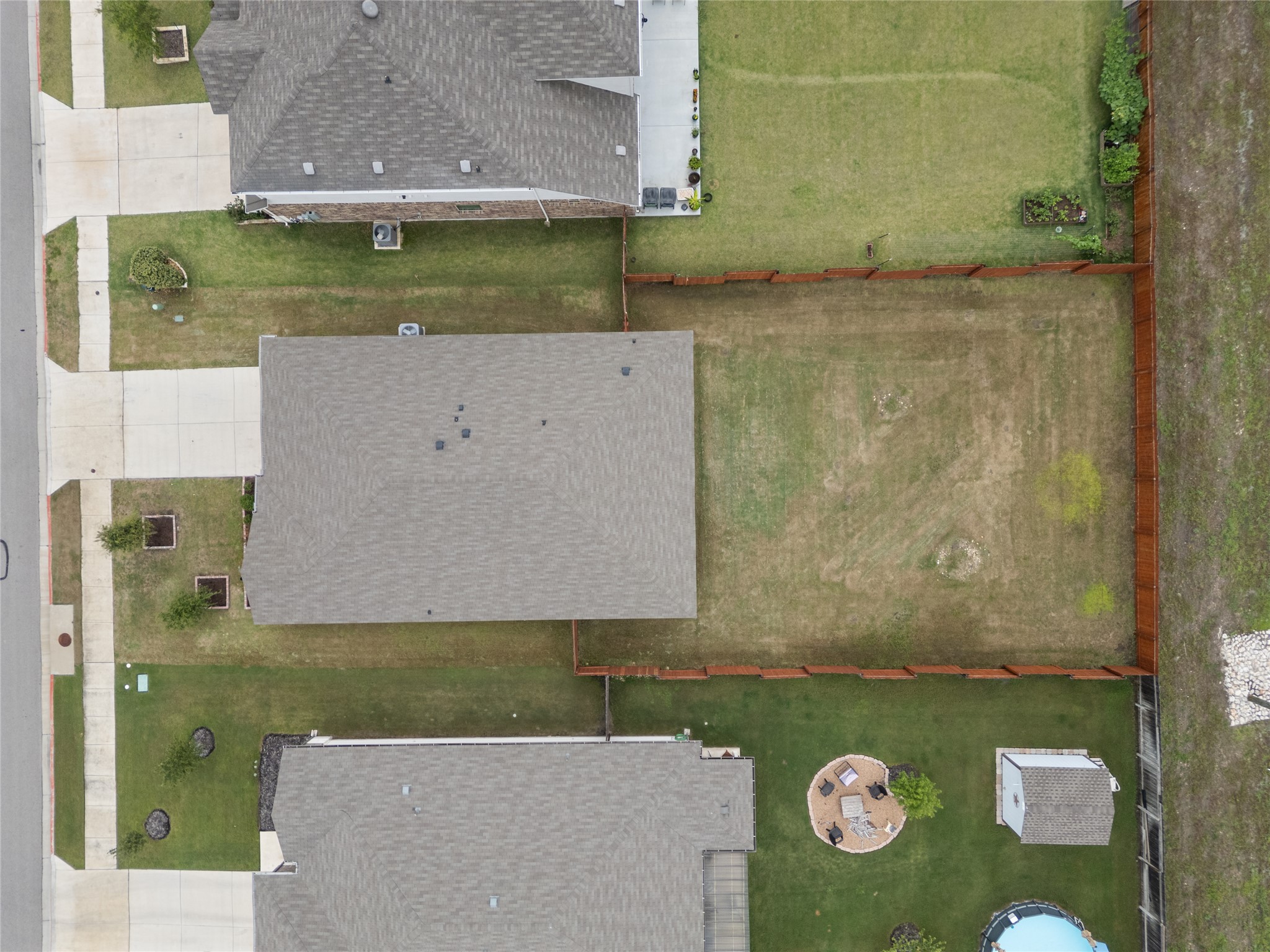 105 Saviano Road Hutto, TX 78634 - Photo 18 of 22 An aerial perspective reveals a verdant yard with a privacy fence, perfect for outdoor enjoyment.