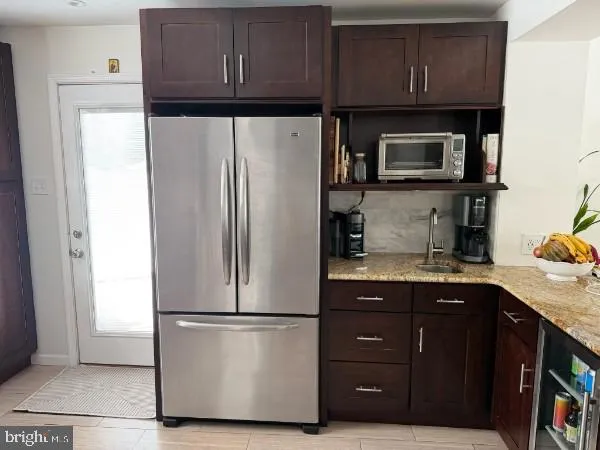 a kitchen with stainless steel appliances granite countertop a refrigerator stove and sink