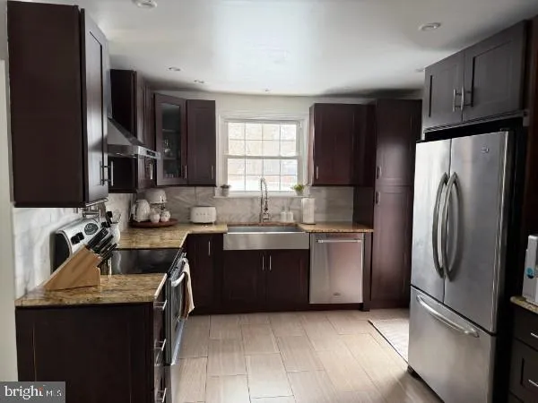 a kitchen with stainless steel appliances a stove and a refrigerator