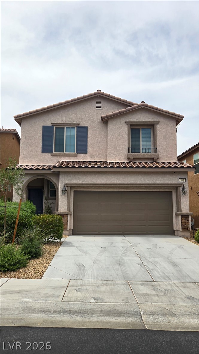 891 Earth Luster Road Las Vegas, NV 89178 - Photo 1 of 20 Stucco exterior walls paired with a tile roof define this two-story residential facade.