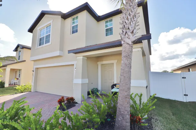 front view of a house with potted plants