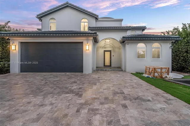 a view of a house with a yard and garage