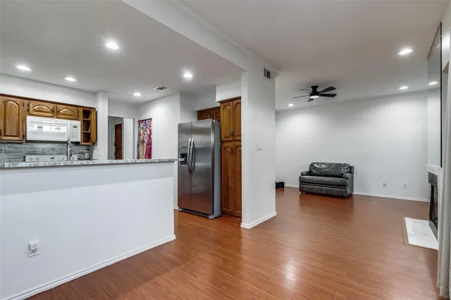 a kitchen with stainless steel appliances a refrigerator and a stove top oven