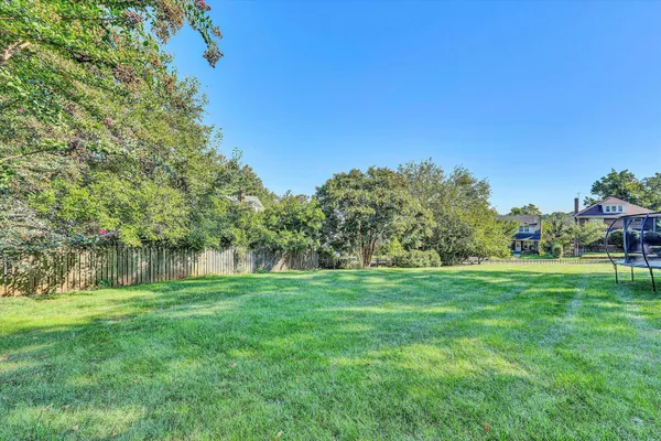 a view of a grassy field with trees
