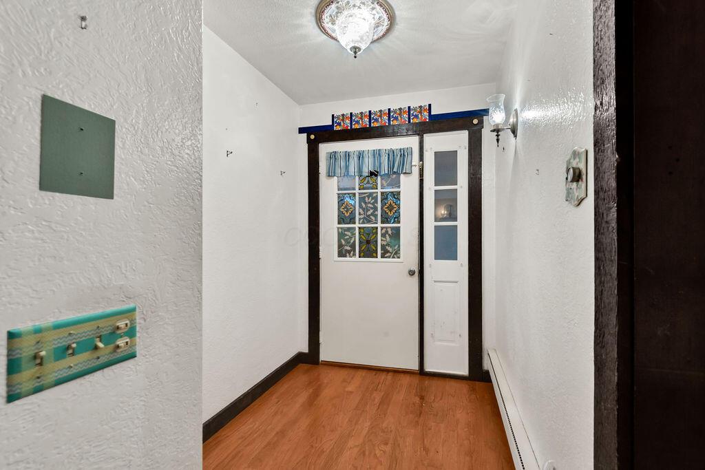 4409 Newton Road Northeast Newark, OH 43055 - Photo 7 of 87 • Wood flooring • Venetian plaster walls • Ceiling light • Lighted coat closet
