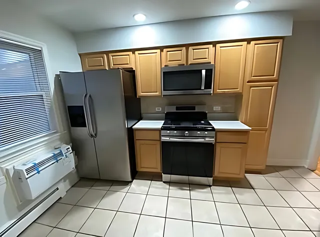 a kitchen with stainless steel appliances a refrigerator and a stove top oven