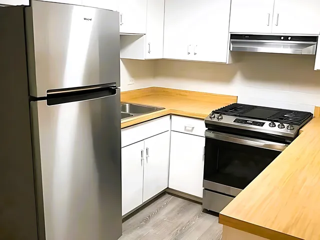 a view of a kitchen with wooden floor