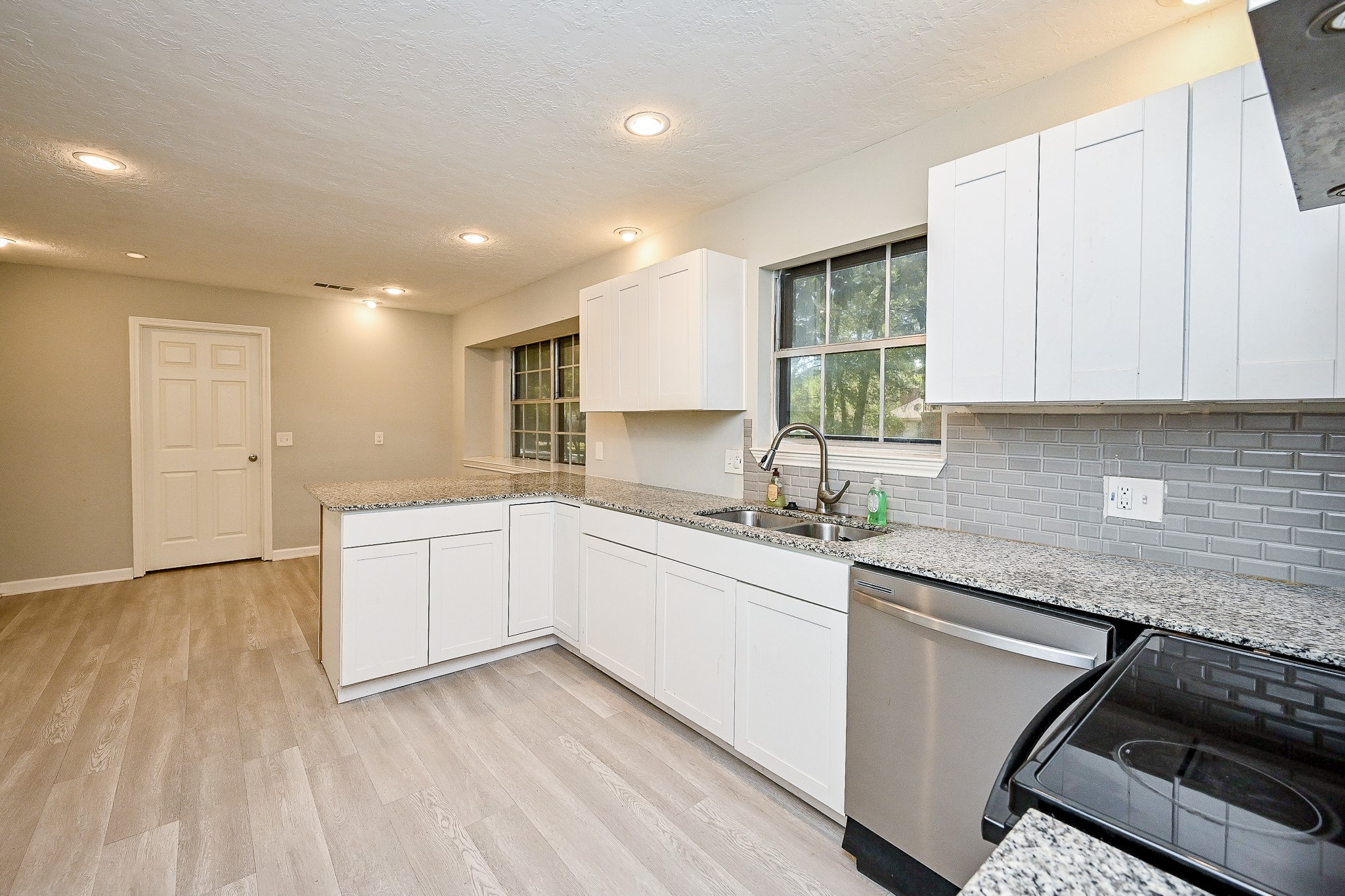 602 Mobile Court Conroe, TX 77302 - Photo 13 of 30 a kitchen with a sink window and cabinets