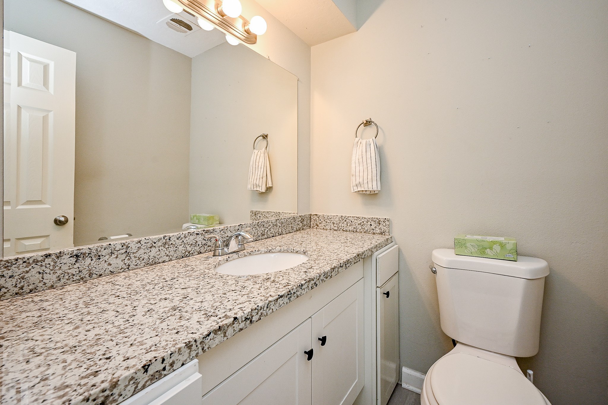602 Mobile Court Conroe, TX 77302 - Photo 16 of 30 a bathroom with a granite countertop toilet sink and mirror