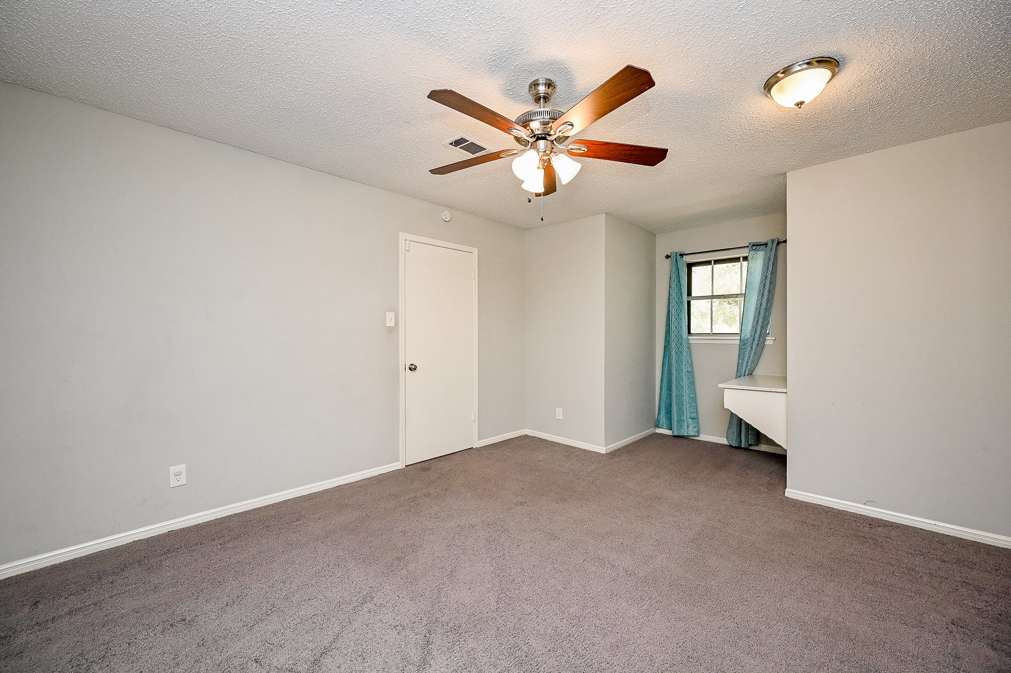 602 Mobile Court Conroe, TX 77302 - Photo 23 of 30 an empty room with closet and a ceiling fan