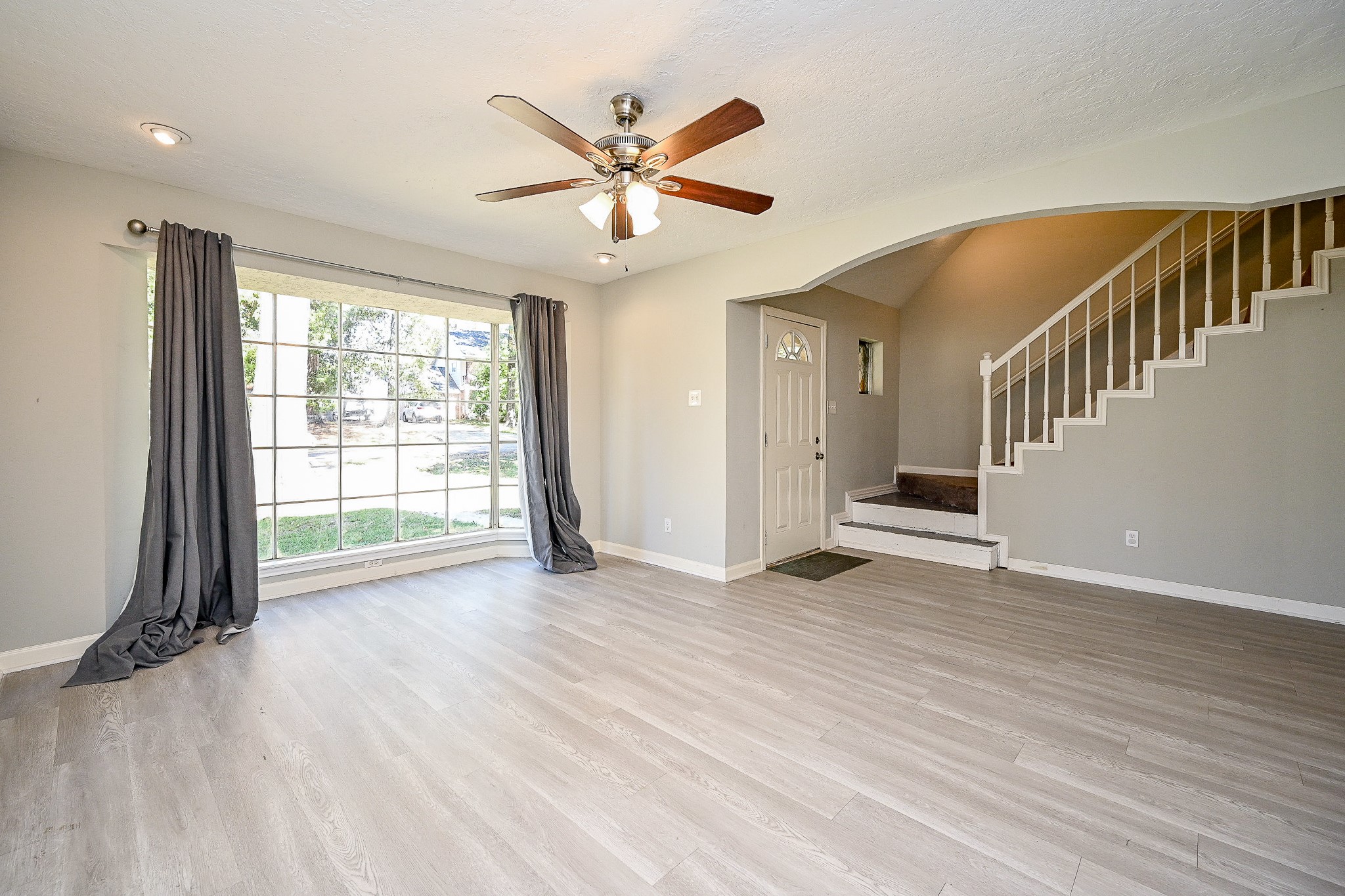 602 Mobile Court Conroe, TX 77302 - Photo 5 of 30 an empty room with wooden floor fan and windows