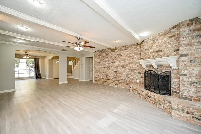 a view of a livingroom with an empty space and a fireplace
