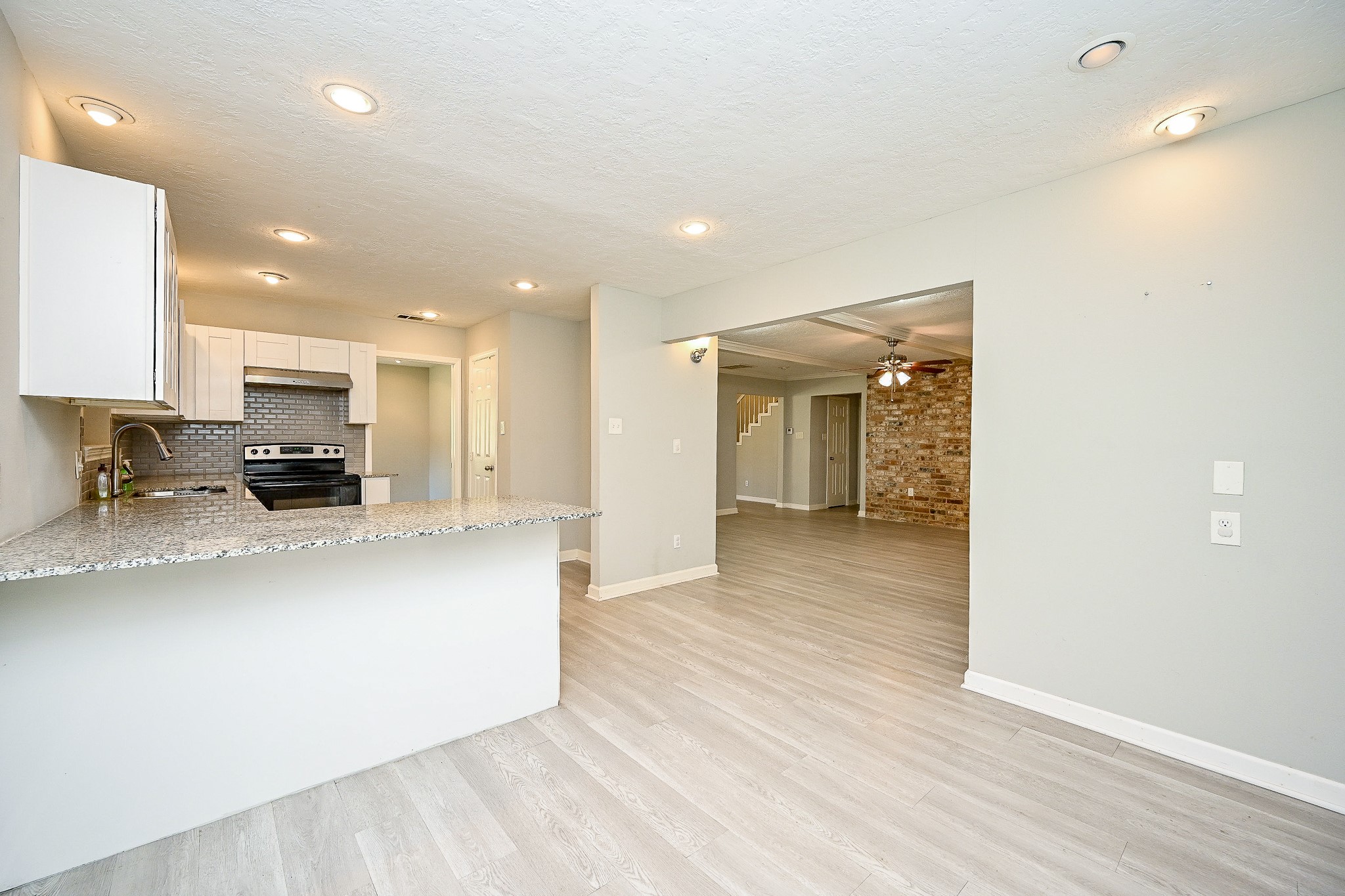 602 Mobile Court Conroe, TX 77302 - Photo 9 of 30 a view of kitchen with stainless steel appliances granite countertop a refrigerator a sink a stove and a wooden floors