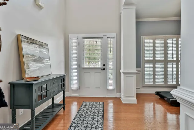 a living room with furniture a fireplace and a large window