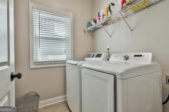 a spacious bedroom with a bed and a chandelier