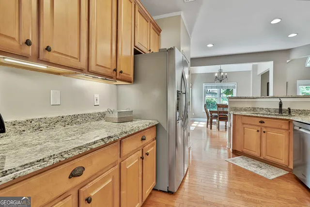 a living room with furniture a chandelier and a flat screen tv