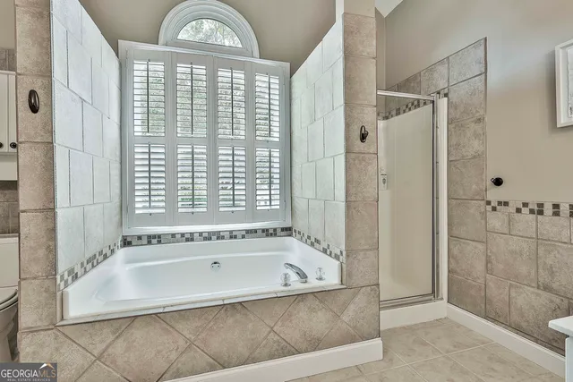 a patio with table and chairs and potted plants