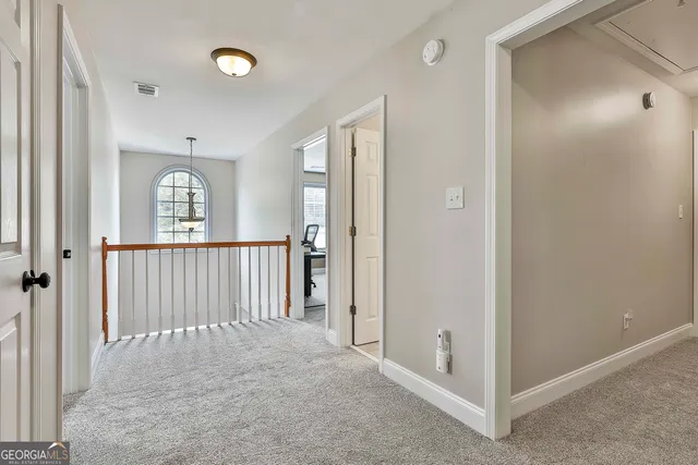 a view of a patio with table and chairs and potted plants with large trees