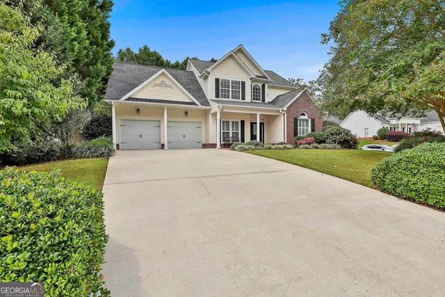 a front view of a house with a yard and garage