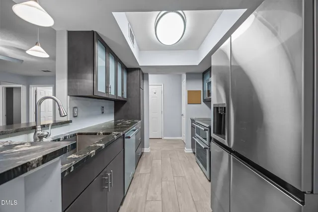 a view of a kitchen with a sink stainless steel appliances and cabinets