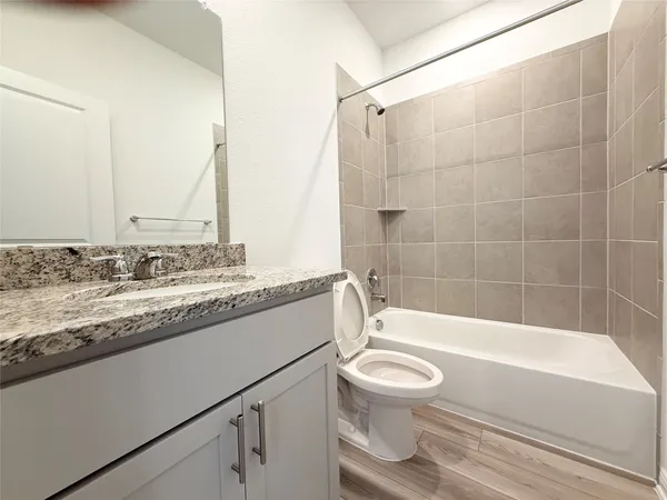 a utility room with wooden floor washer and dryer
