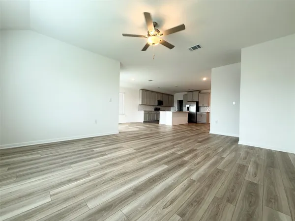a kitchen with a sink a counter top space stainless steel appliances and cabinets
