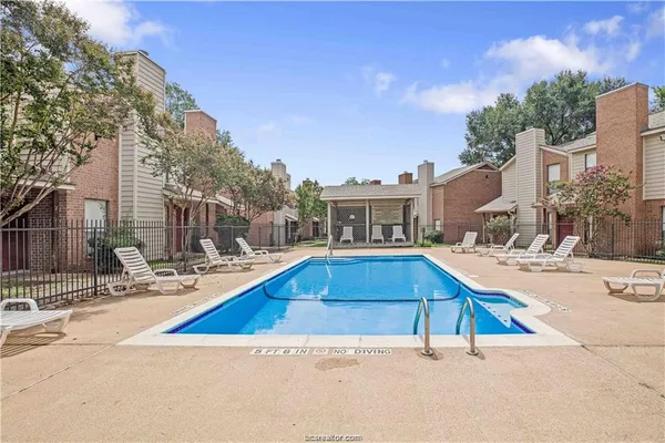 a swimming pool with outdoor seating and yard