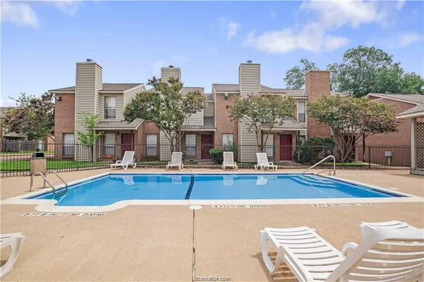 a view of a swimming pool in front of a building