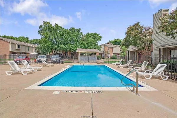 a swimming pool with outdoor seating and yard