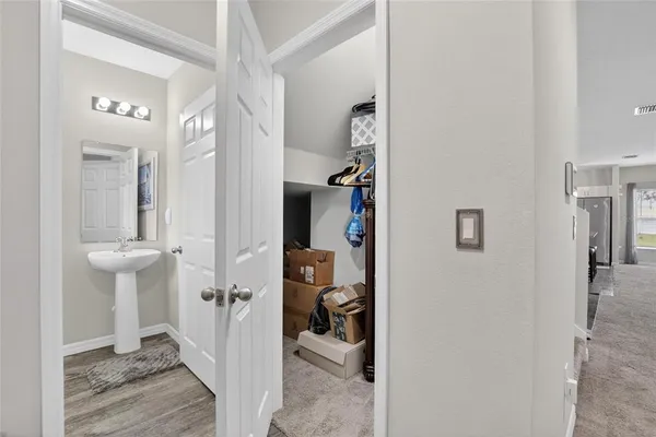 a en suite bathroom with a granite countertop sink and a mirror