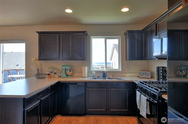 a kitchen with a sink a stove and cabinets
