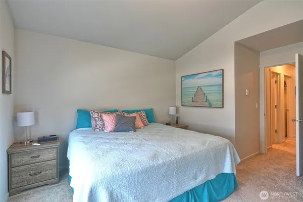 a bedroom with a bed and a night stand