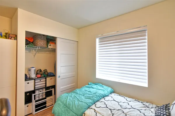 a bedroom with a bed and a window