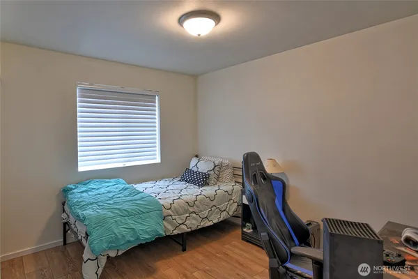 a bedroom with bed and a window