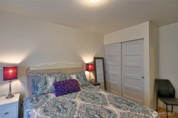 a bedroom with a bed and a dresser in it