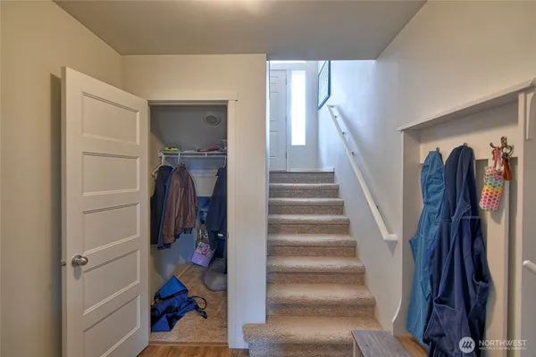 a view of walk in closet with clothes and shoes
