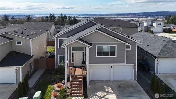 an aerial view of a house with a yard