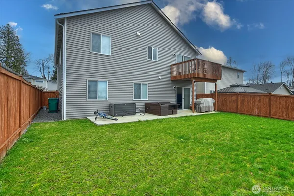 a backyard of a house with table and chairs