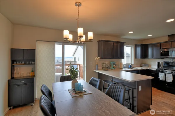 a kitchen with stainless steel appliances granite countertop a sink a stove and a refrigerator