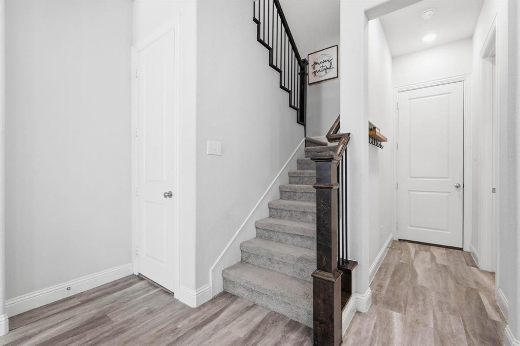 1567 Windermere Way Dallas, TX 75234 - Photo 12 of 26 a view of entryway with wooden floor and stairs