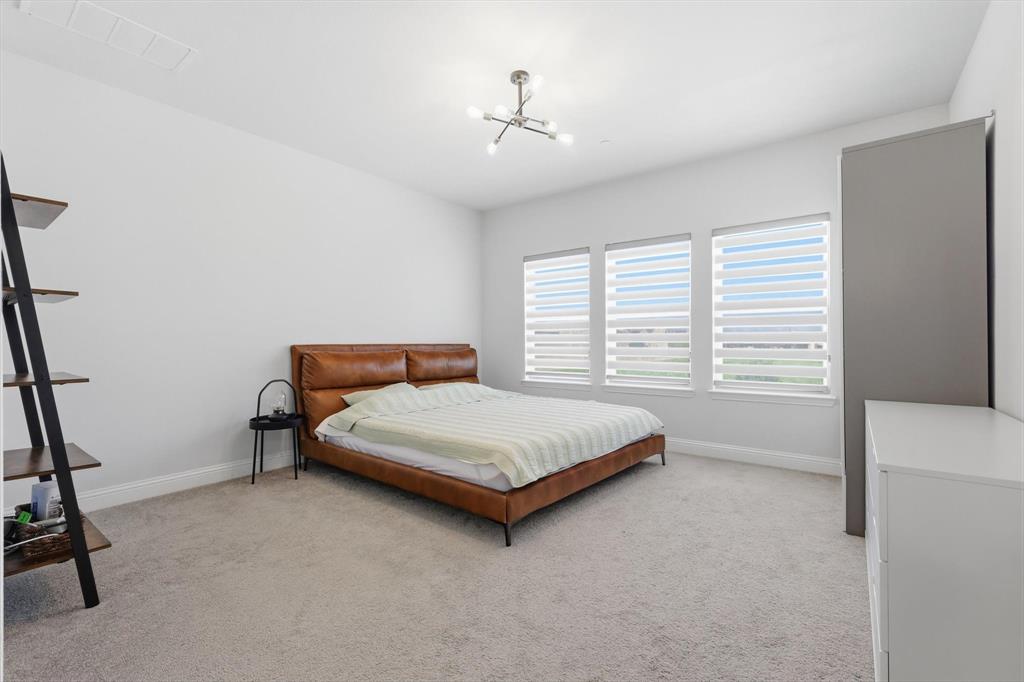 1567 Windermere Way Dallas, TX 75234 - Photo 15 of 26 a bedroom with a bed and a window